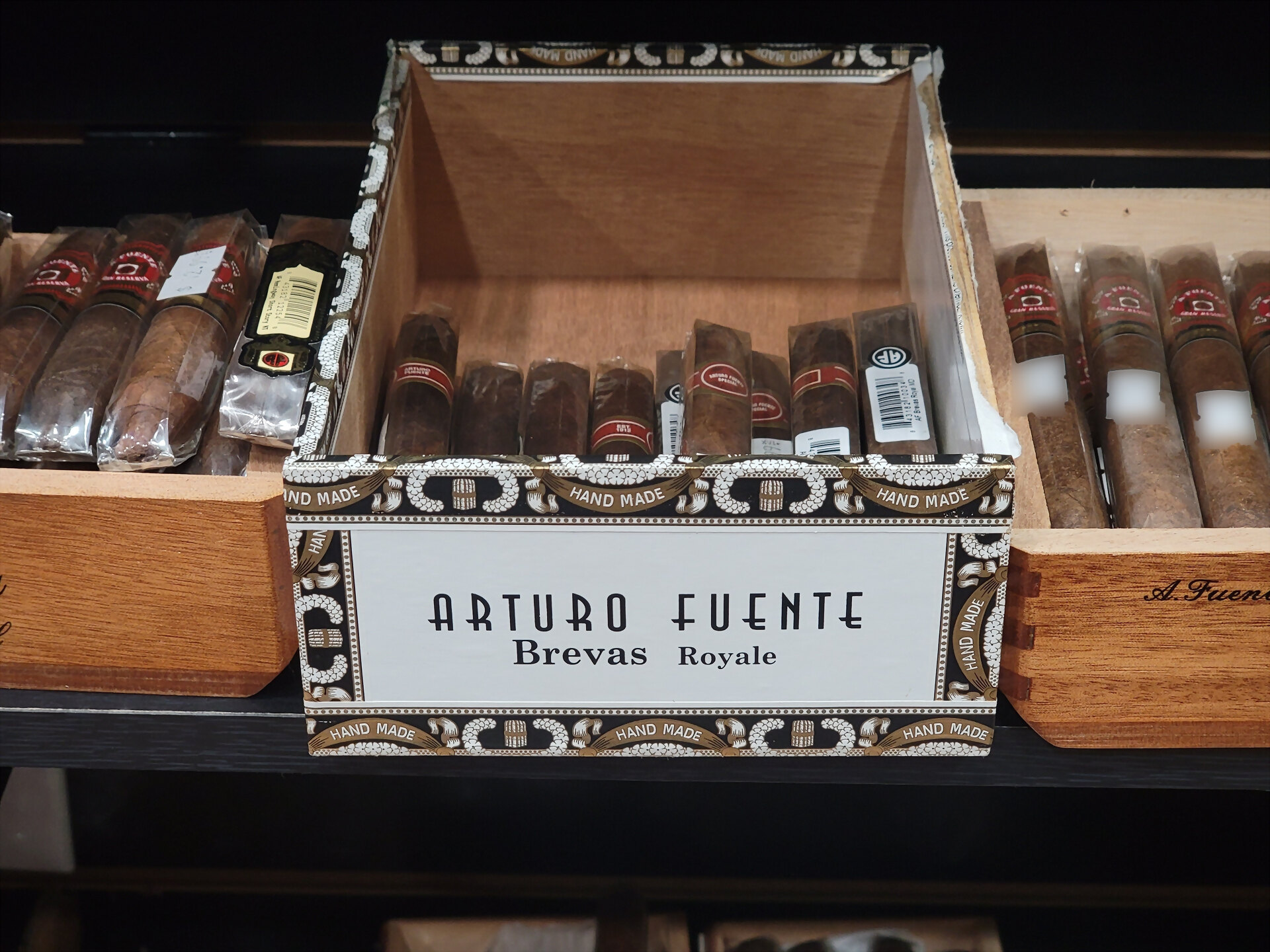 An Arturo Fuente Brevas Royale box open on the shelf