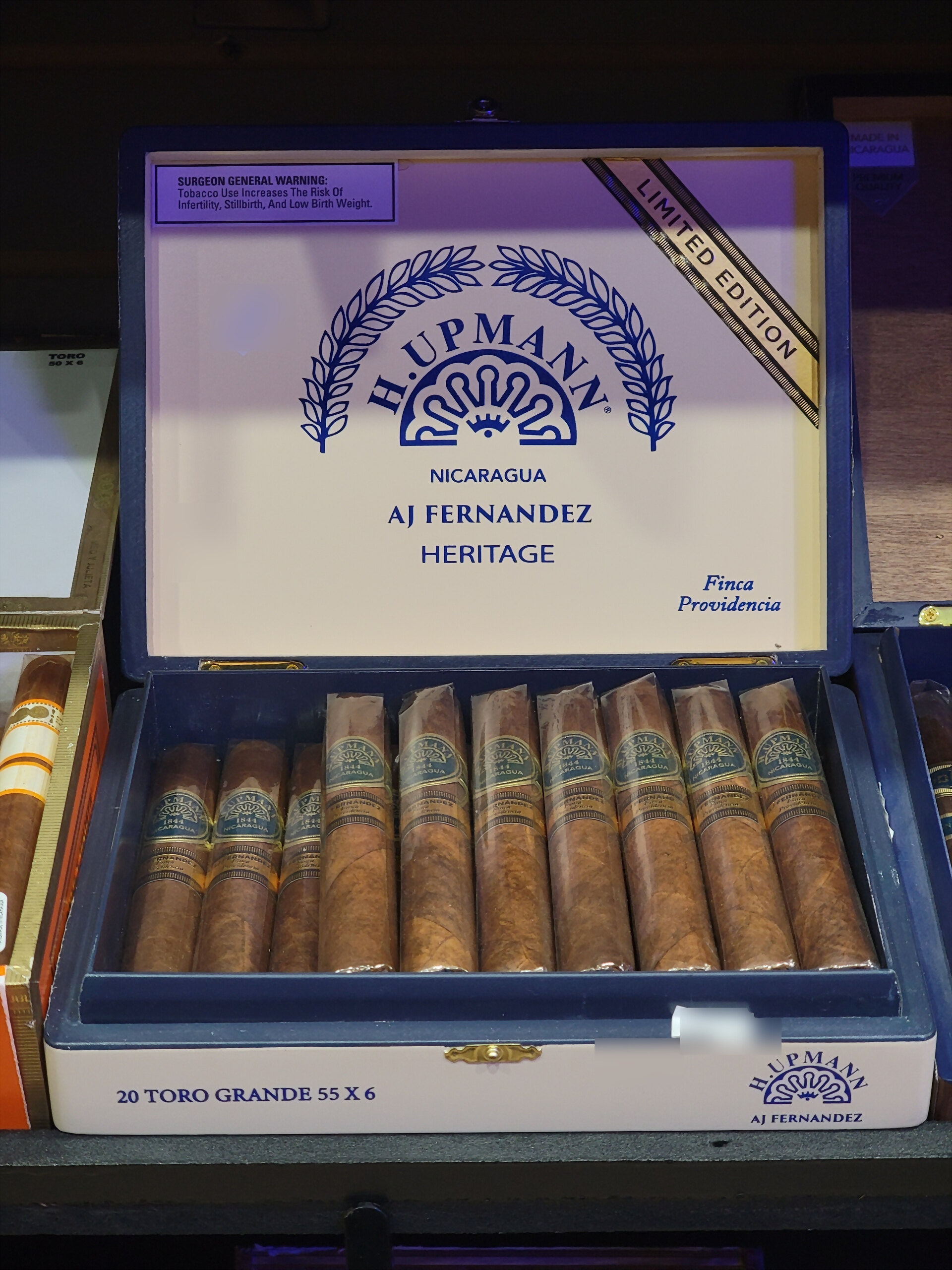 An H. Upmann by AJ Fernandez Heritage box open, 20 TORO GRANDE 55 X 6 on the front rail