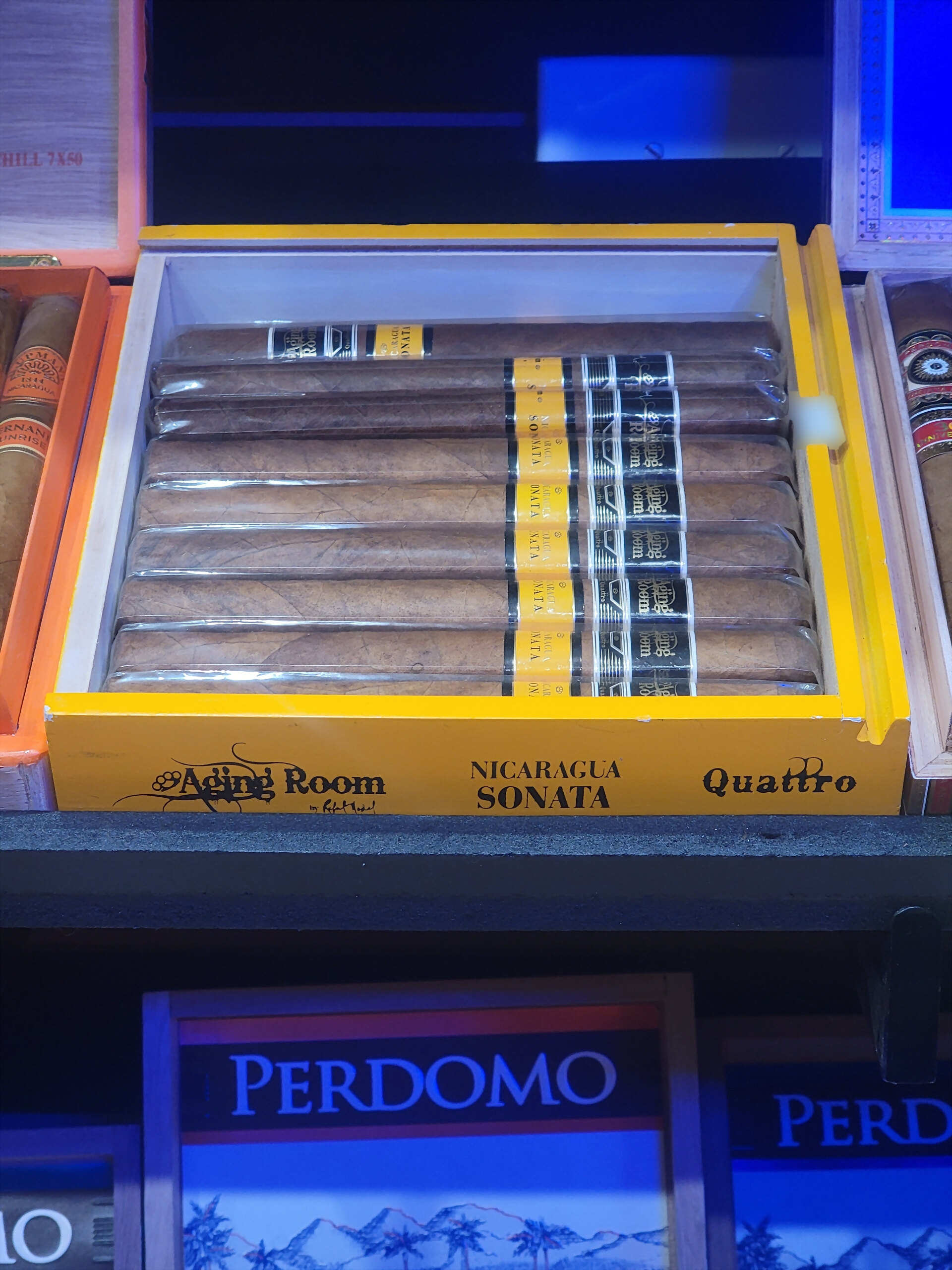 An Aging Room Quattro Nicaragua box, NICARAGUA SONATA Quattro across the yellow front rail