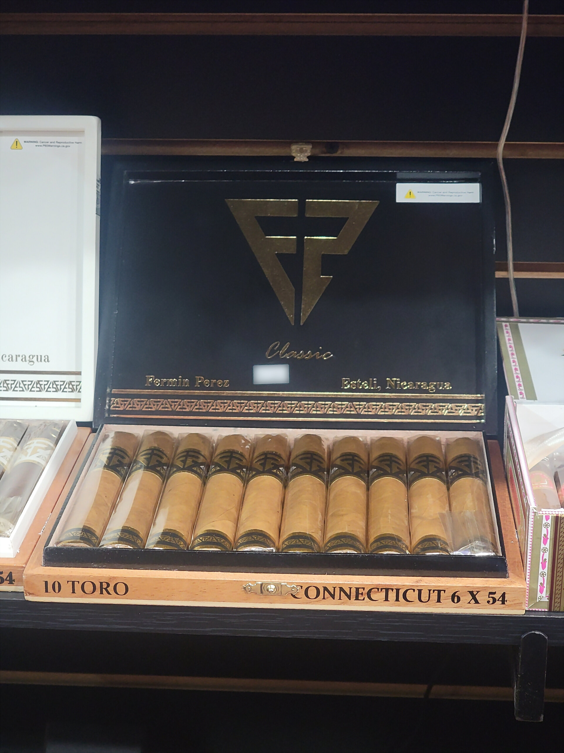 An FP Classic box open on the shelf, 10 TORO CONNECTICUT 6 X 54 on the front rail