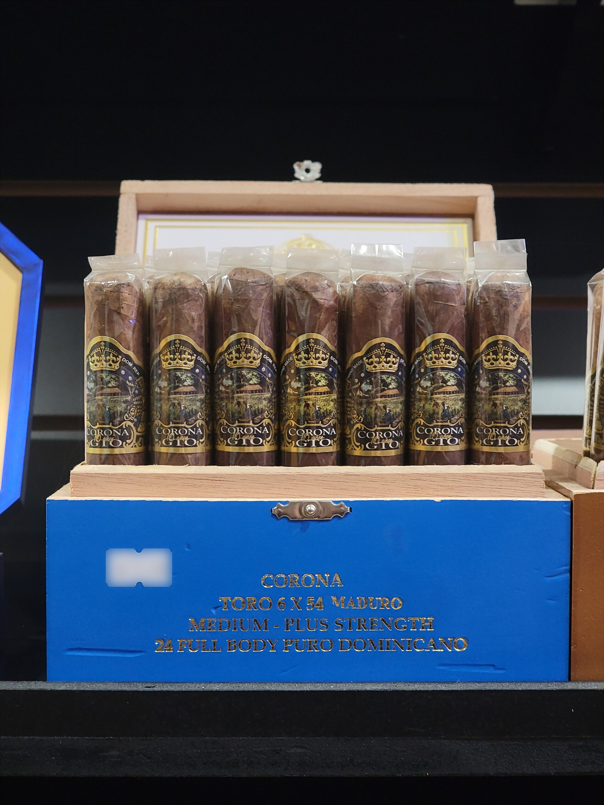 A blue Corona GTO Maduro box of toros on the humidor shelf