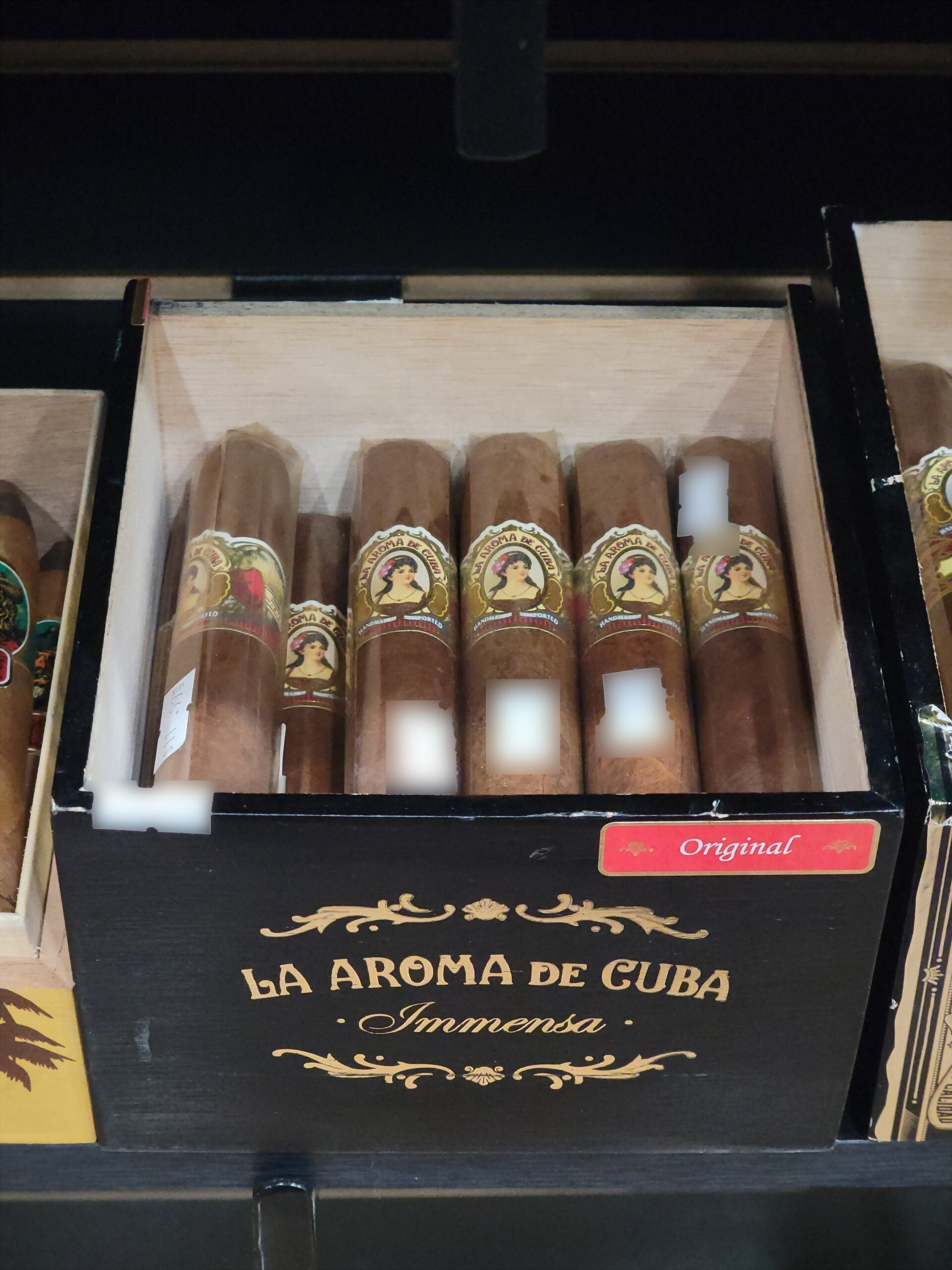 A La Aroma de Cuba Immensa box open on the shelf, a red Original tab on the front rail