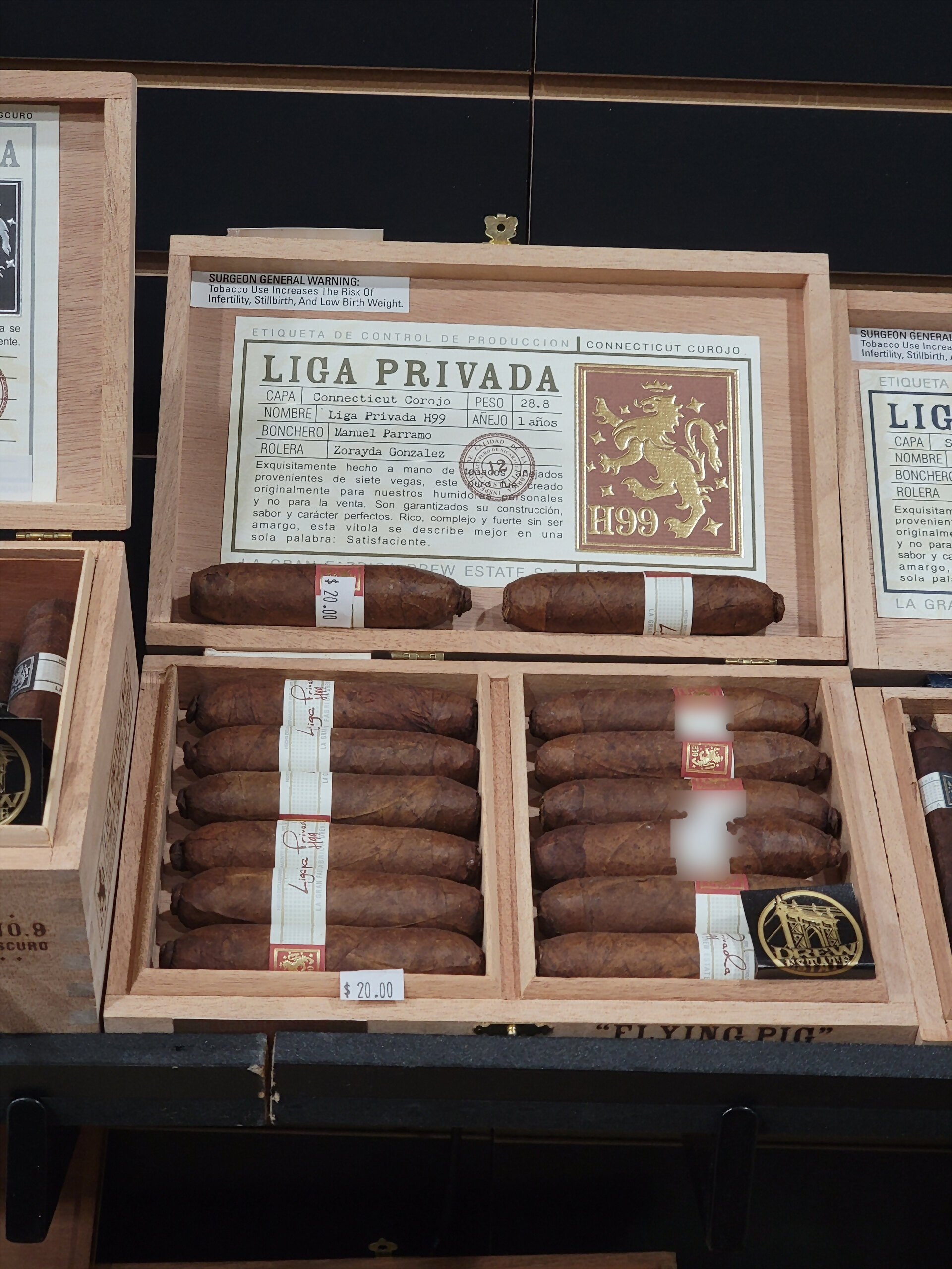 A Liga Privada H99 Flying Pig box open, the production label visible inside the lid