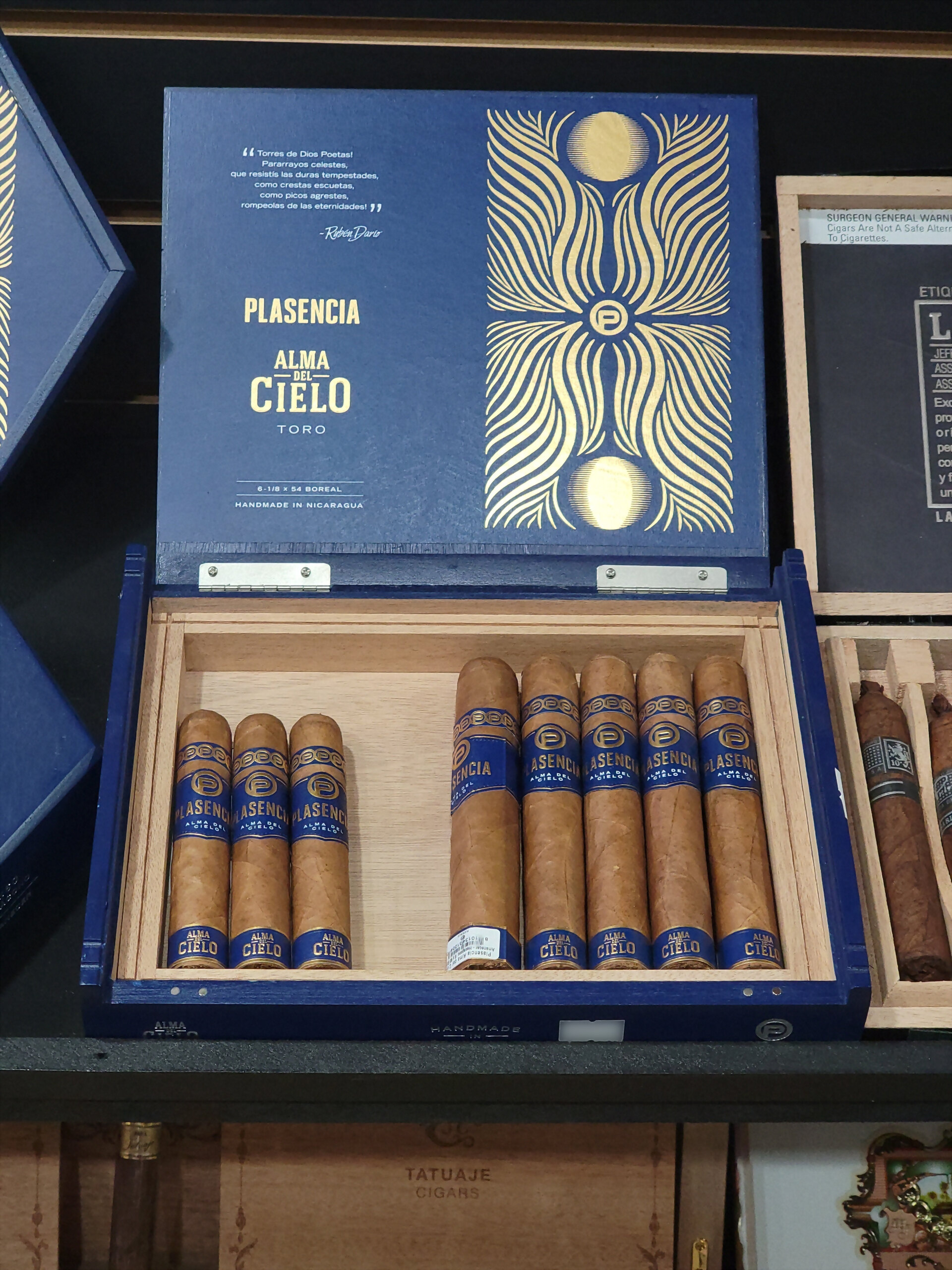 A blue Plasencia Alma del Cielo Toro box, lid raised, showing the gold sunburst artwork