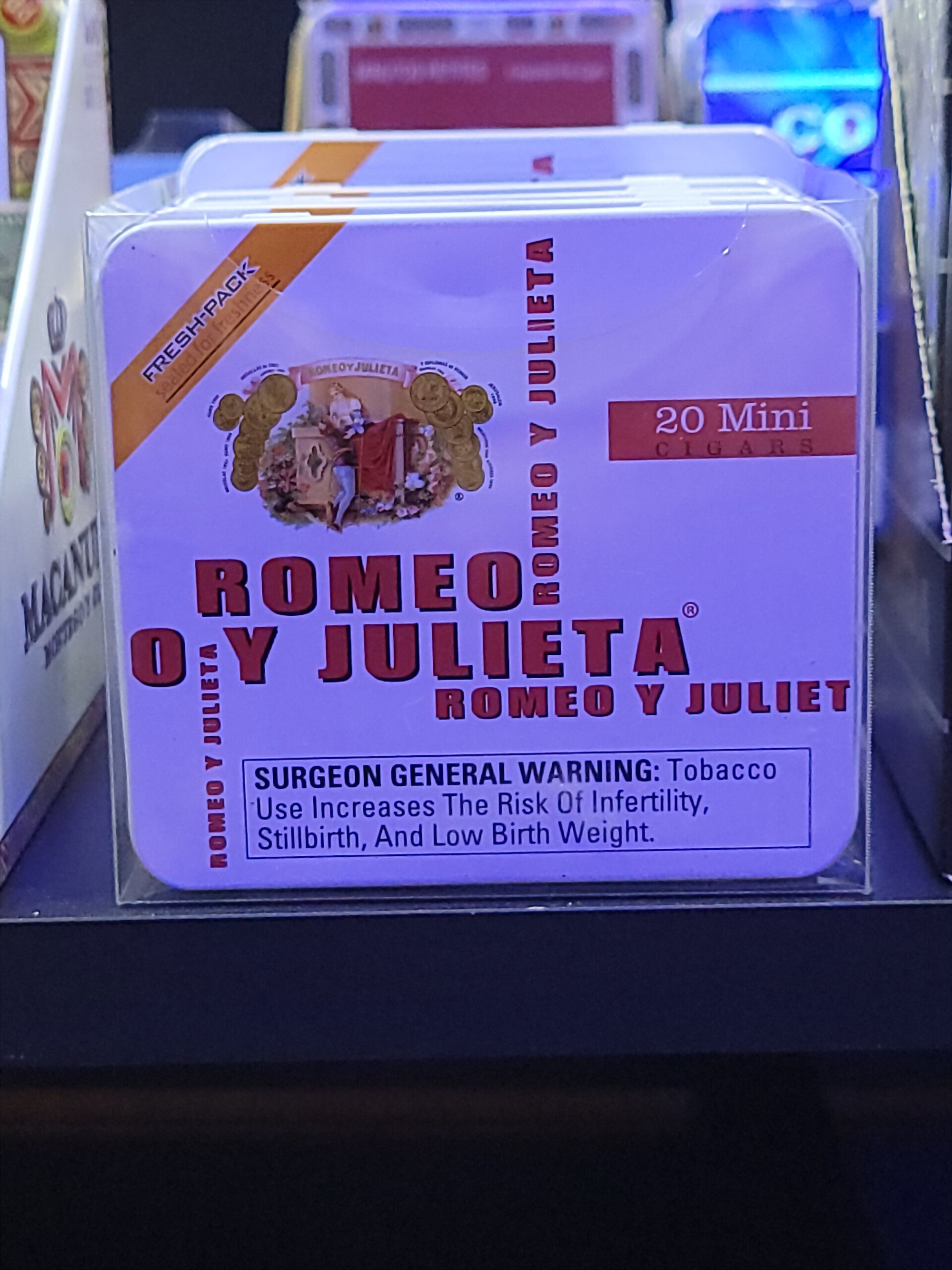 A second Romeo y Julieta 20 Mini Cigars tin on the counter display