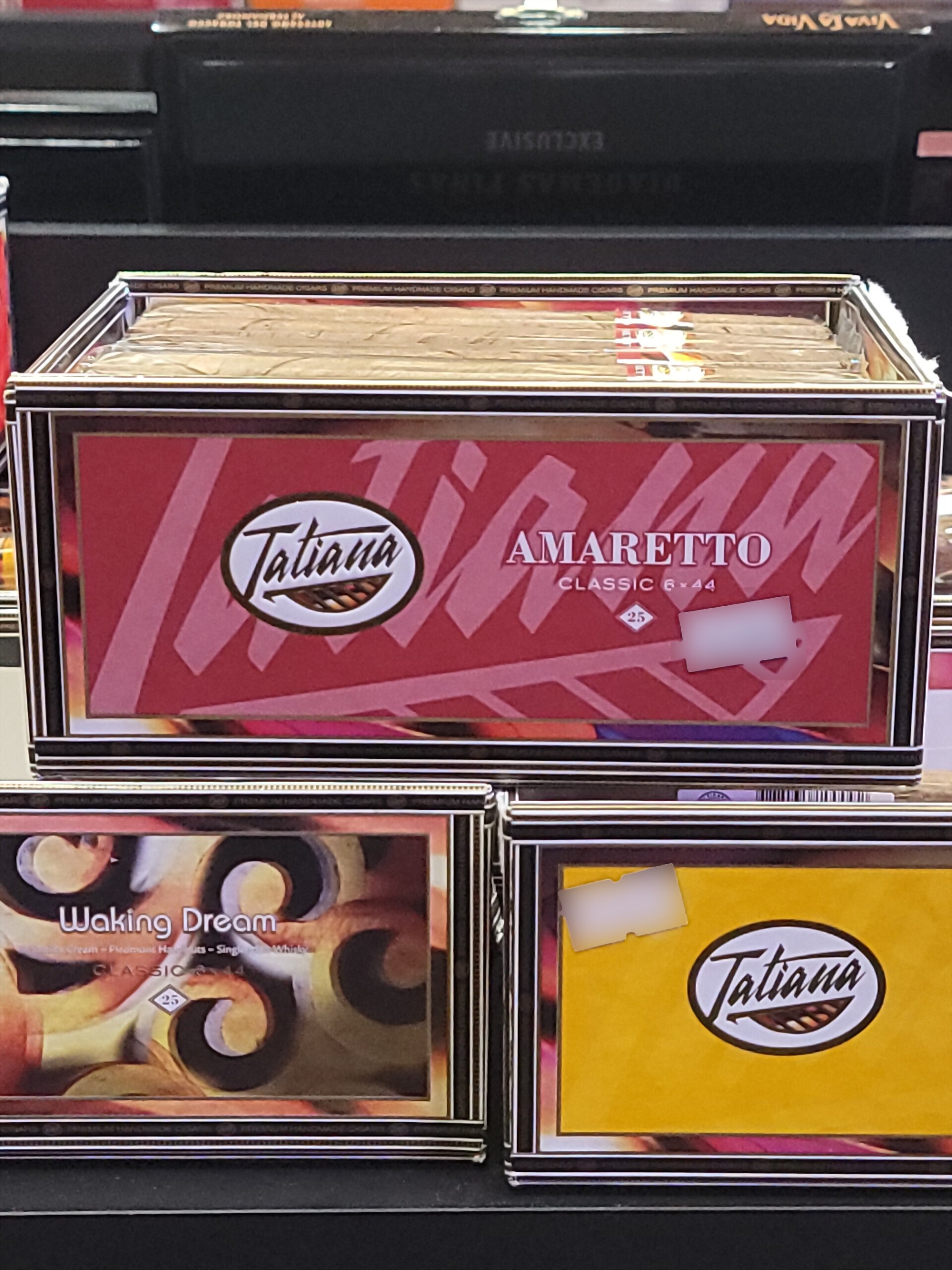 A Tatiana Amaretto box on the shelf, AMARETTO CLASSIC 6x44 across the front panel