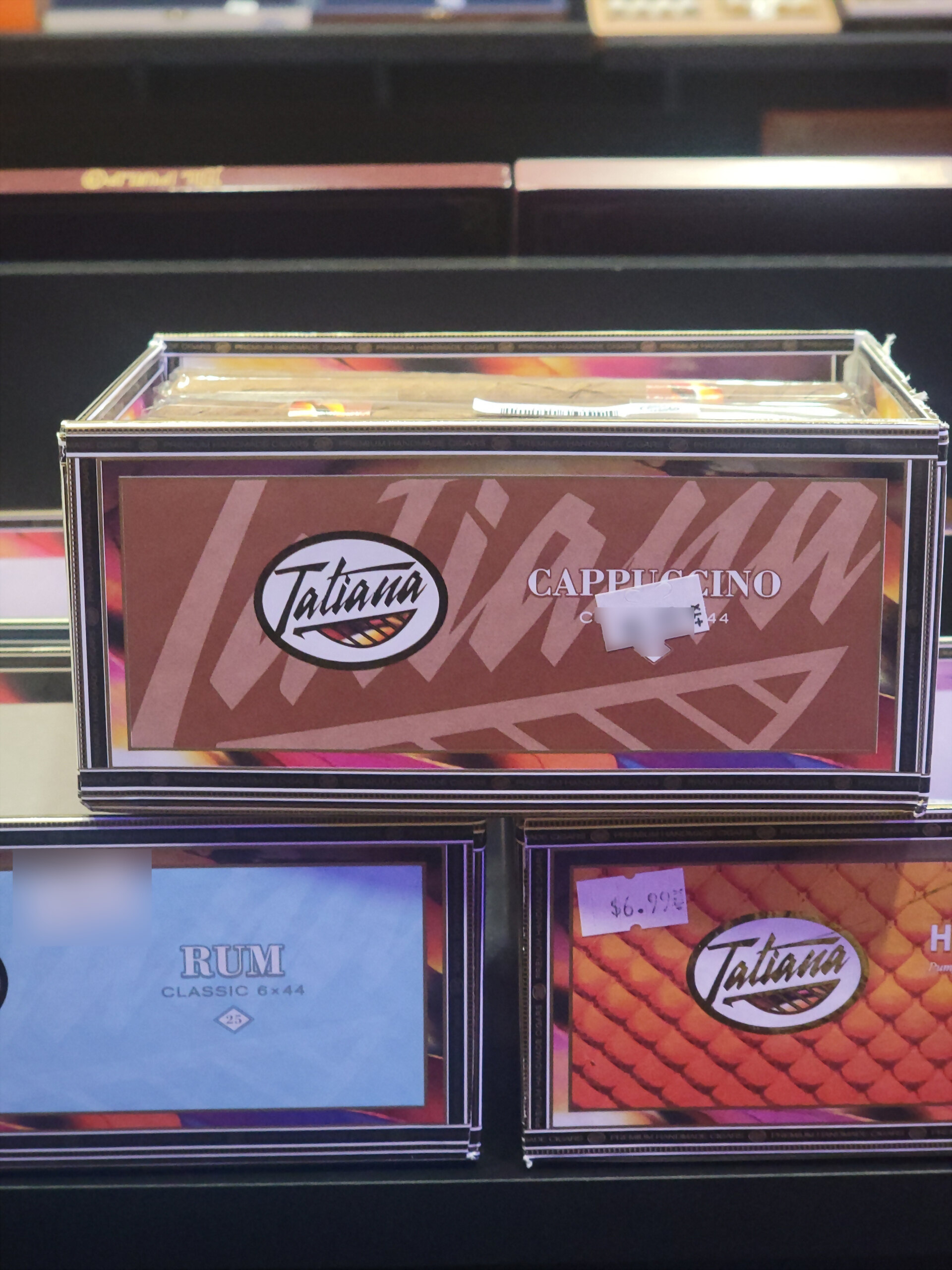 A Tatiana Cappuccino box on the shelf, CAPPUCCINO across the brown front panel